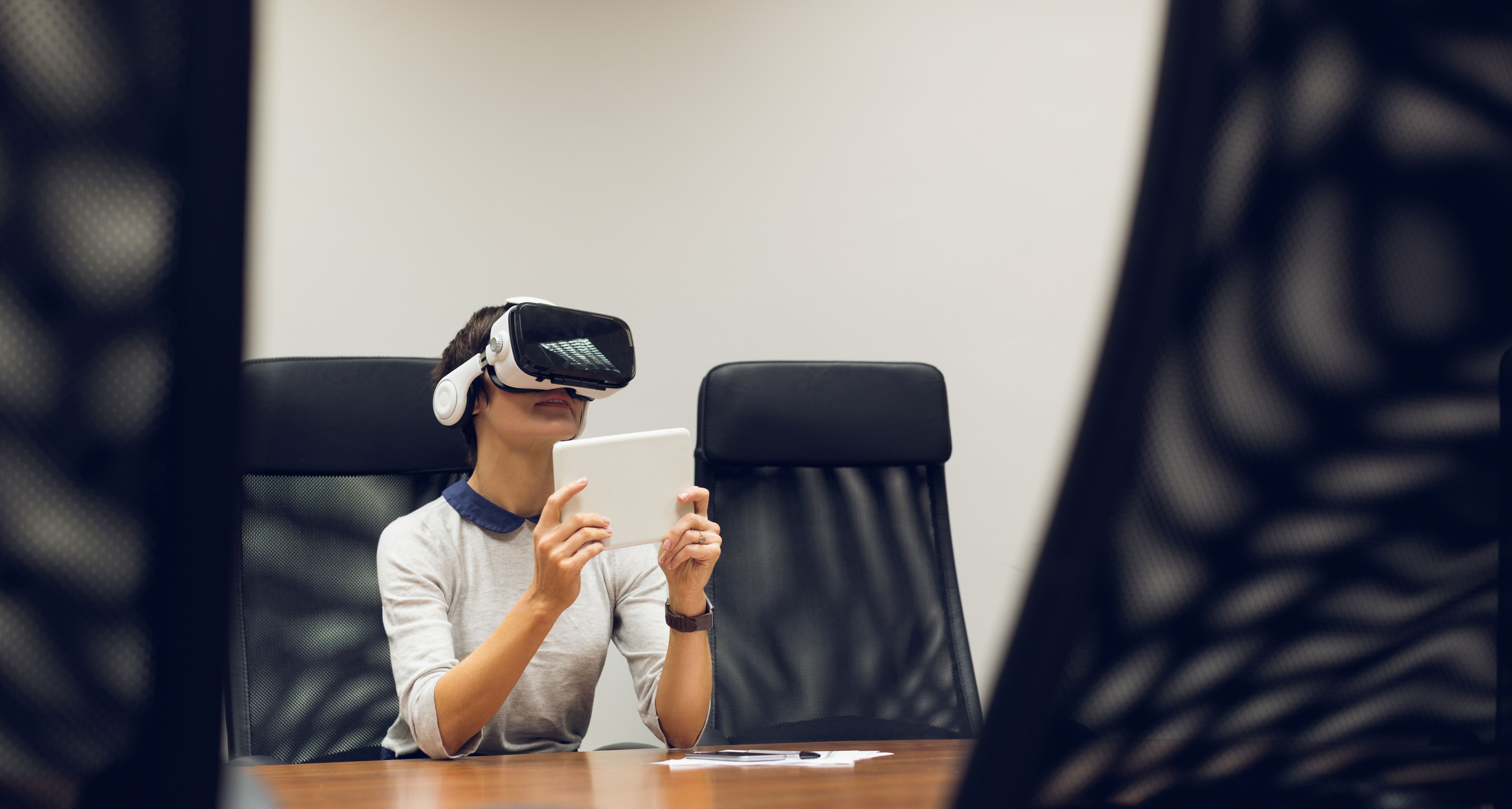 Person using a VR headset to prepare for a job interview in a simulated virtual environment.